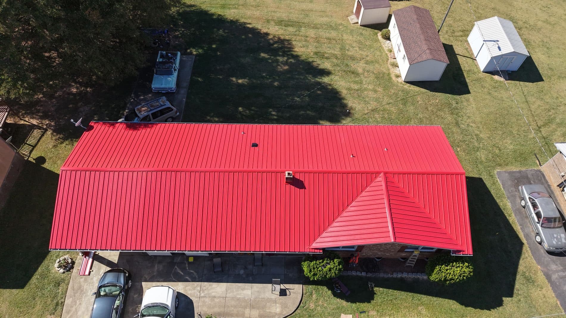 Red standing-seam metal roof installed by Good Roofing