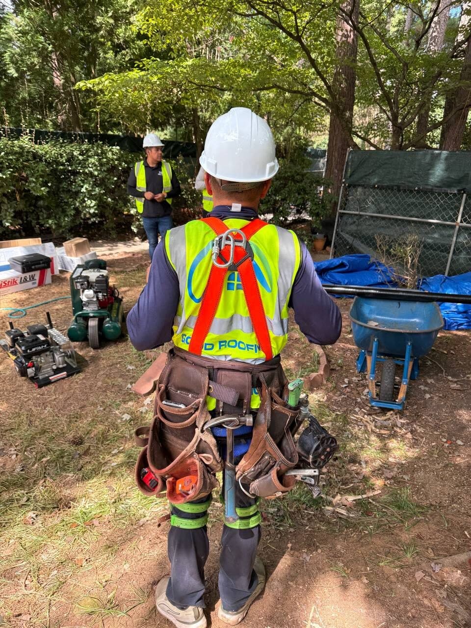 Good Roofing inspector in safety harness checking a roof after a storm