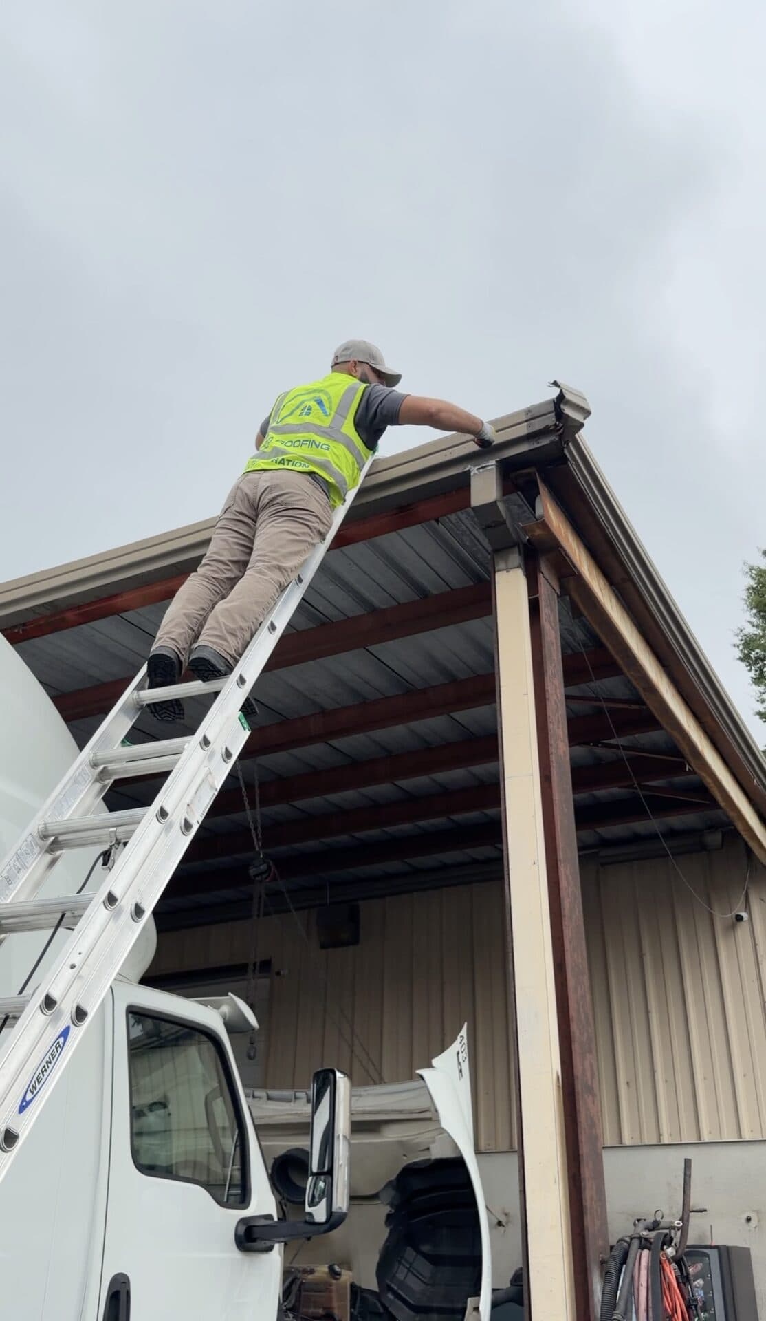 Good Roofing installing gutters on a Charlotte home